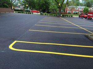 freshly painted parking lines on repaved parking lot with rose paving trucks