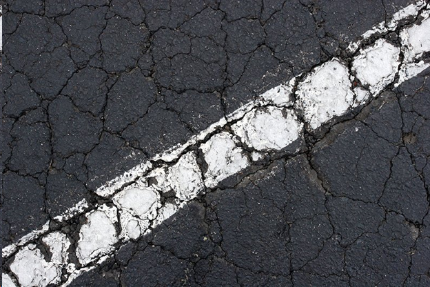 Asphalt repair is needed if you see large cracks like this one in your pavement.