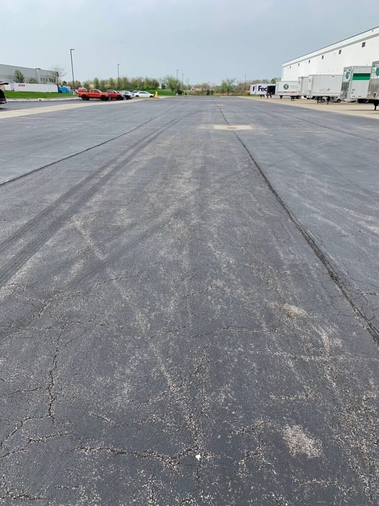 A picture of a parking lot with Joint and Longitudinal Cracks